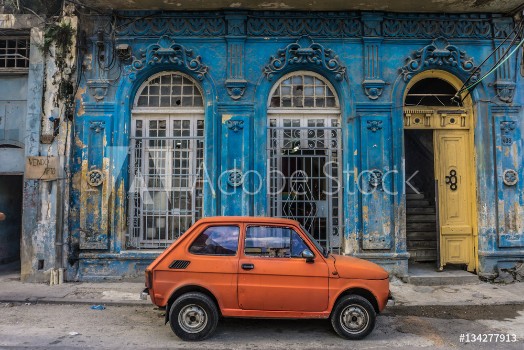 Picture of Old small car in front old blue house general travel imagery on december 26 2016 in La Havana Cuba